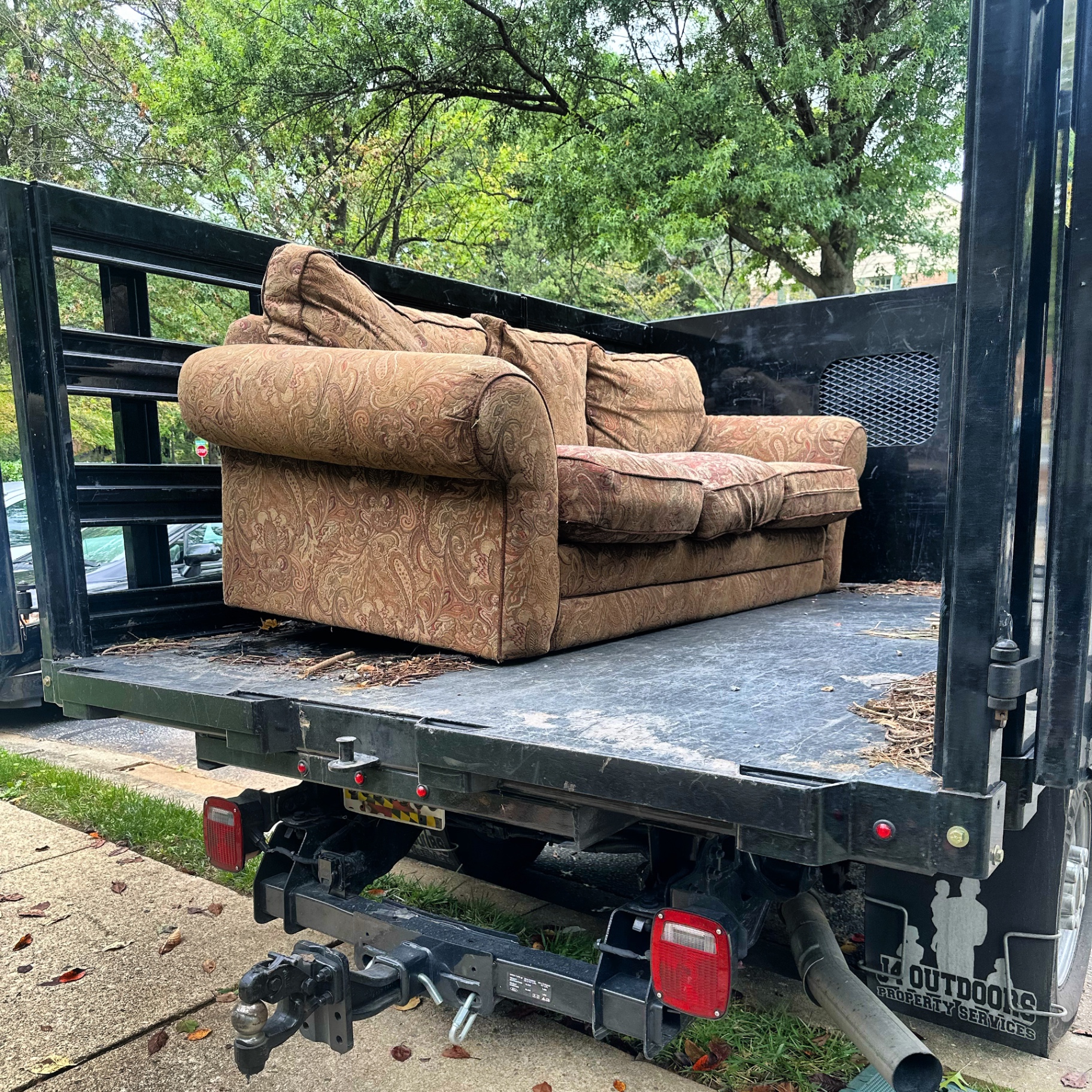 J4 Outdoors removing an old couch